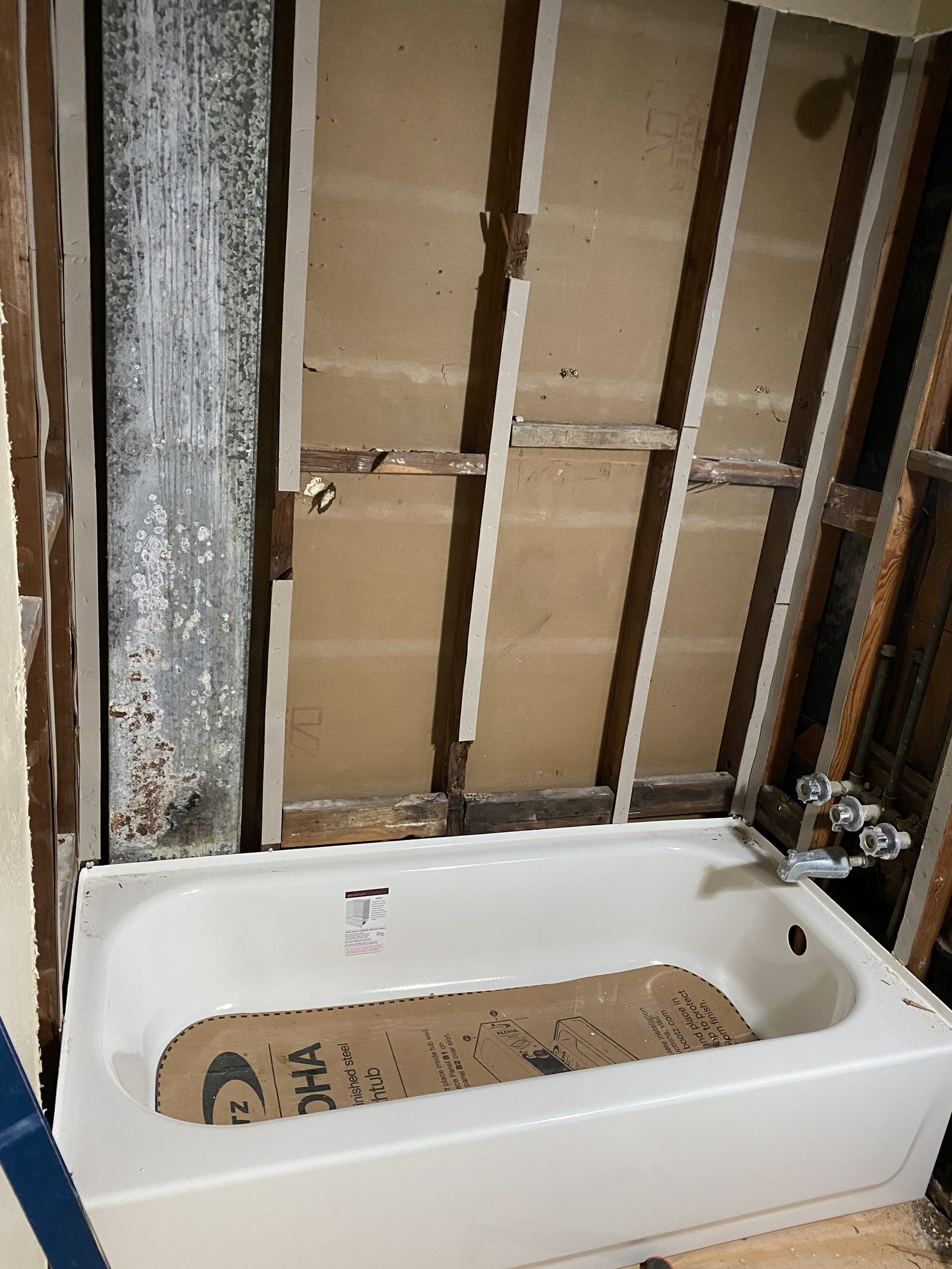 Tub Replacement Prep — Old surround removed, new tub set, walls opened up for a full bath remodel.